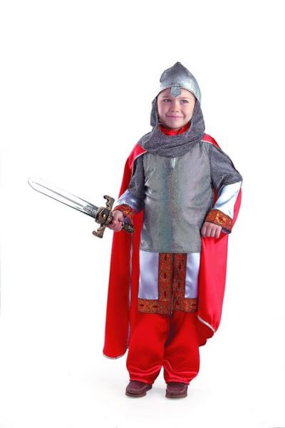 Костюм Богатырь 7015 Костюм Богатыря от Батика для мальчика. В комплекте: рубаха, кольчуга, брюки, шлем, плащ + меч в подарок. 